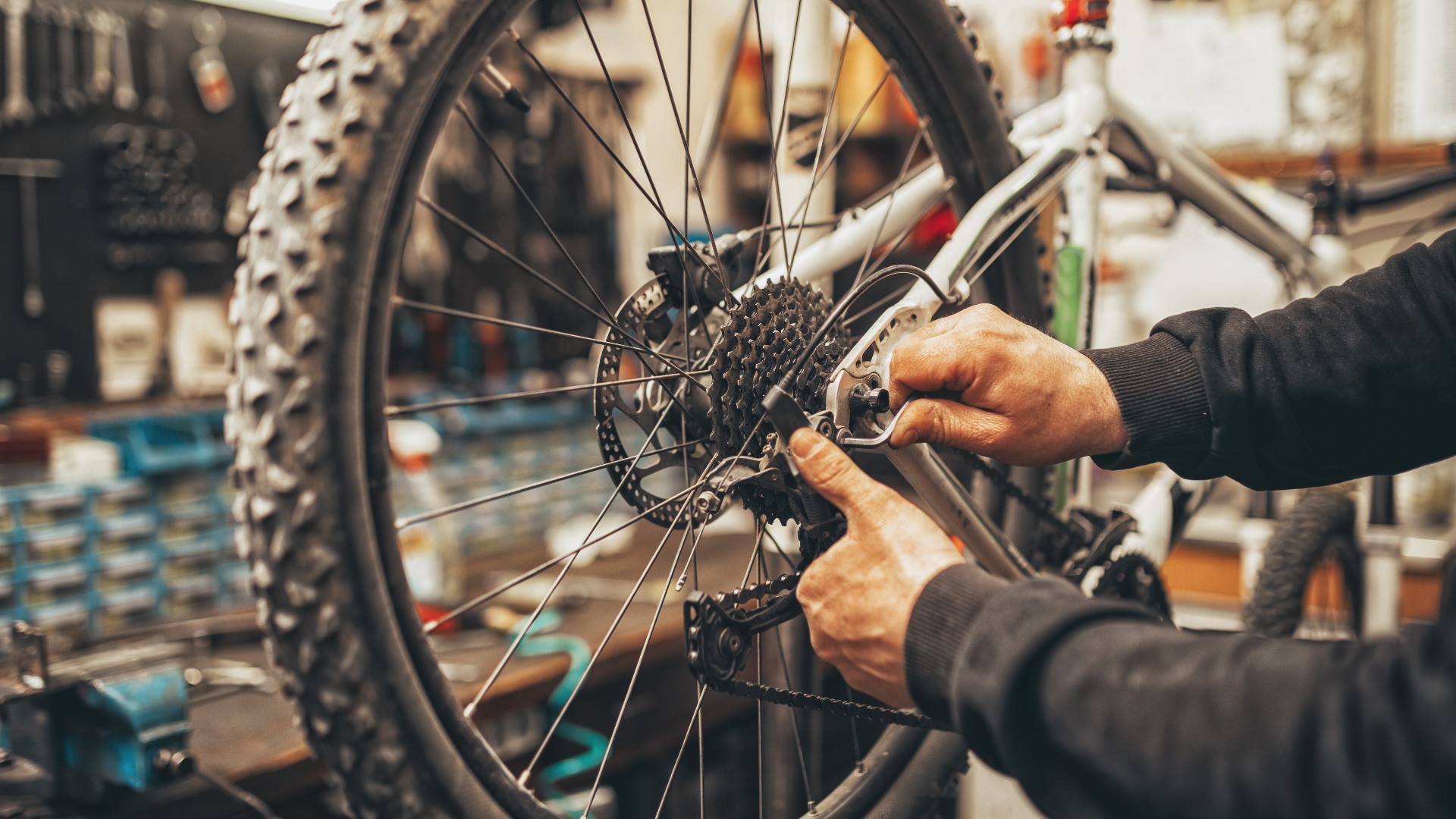 Ein Fahrradmechaniker bei der Reparatur in einer Werkstatt.